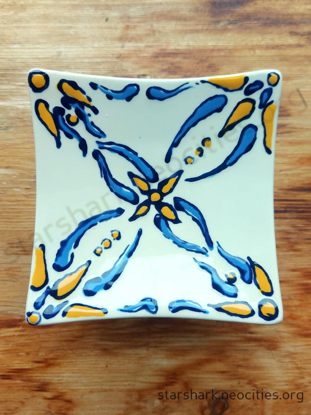 a ceramic trinket dish with blue and yellow portugese tile-style designs